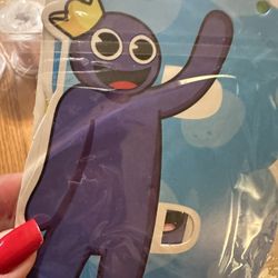 Rainbow Friends, Happy Birthday Banner, Some Toys, And Party Supplies