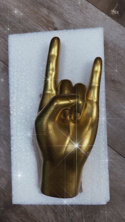 Golden hand sculpture - rock on