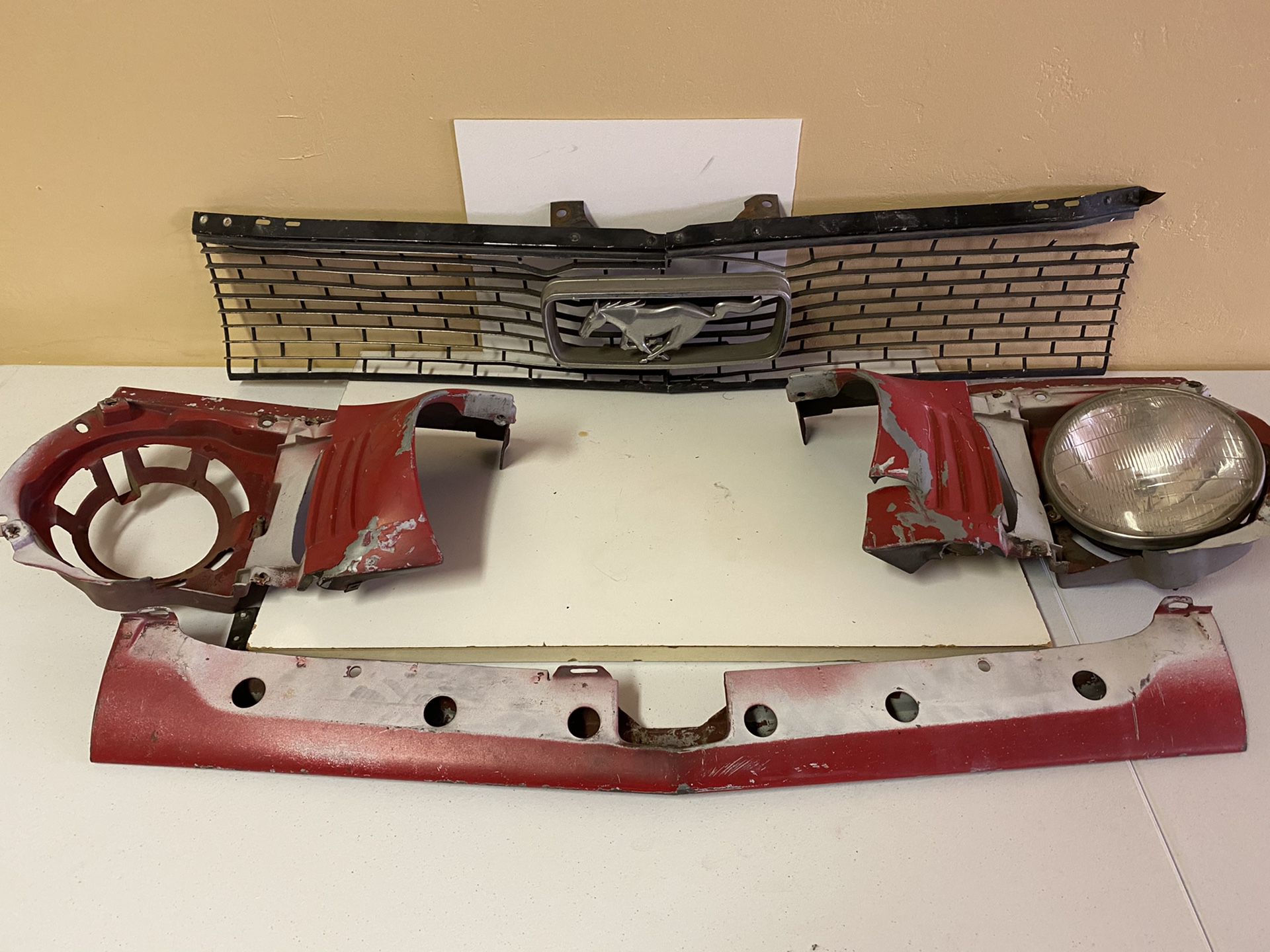 1966 Mustang front parts Grille light brackets etc and back black seat that fits 65-67 coupe