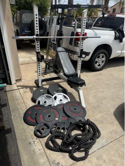 Bench press/squat rack with 7ft 45lbs bar and 260lbs of rubber Olympic weights