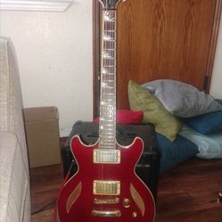 Dean Del Sol semi-hollow electric guitar, specifically featuring a translucent cherry finish.