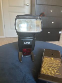 Canon 580 EX II speedlite flash with CP-E4 battery pack.