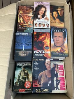 VHS movies 2 boxes full of assorted movies.