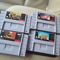 4 super Nintendo games.
Mario kart 
Donkey Kong Country 2
Mortal Kombat 
Aladdin all excellent condition 