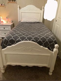 white twin bed frame and mattress