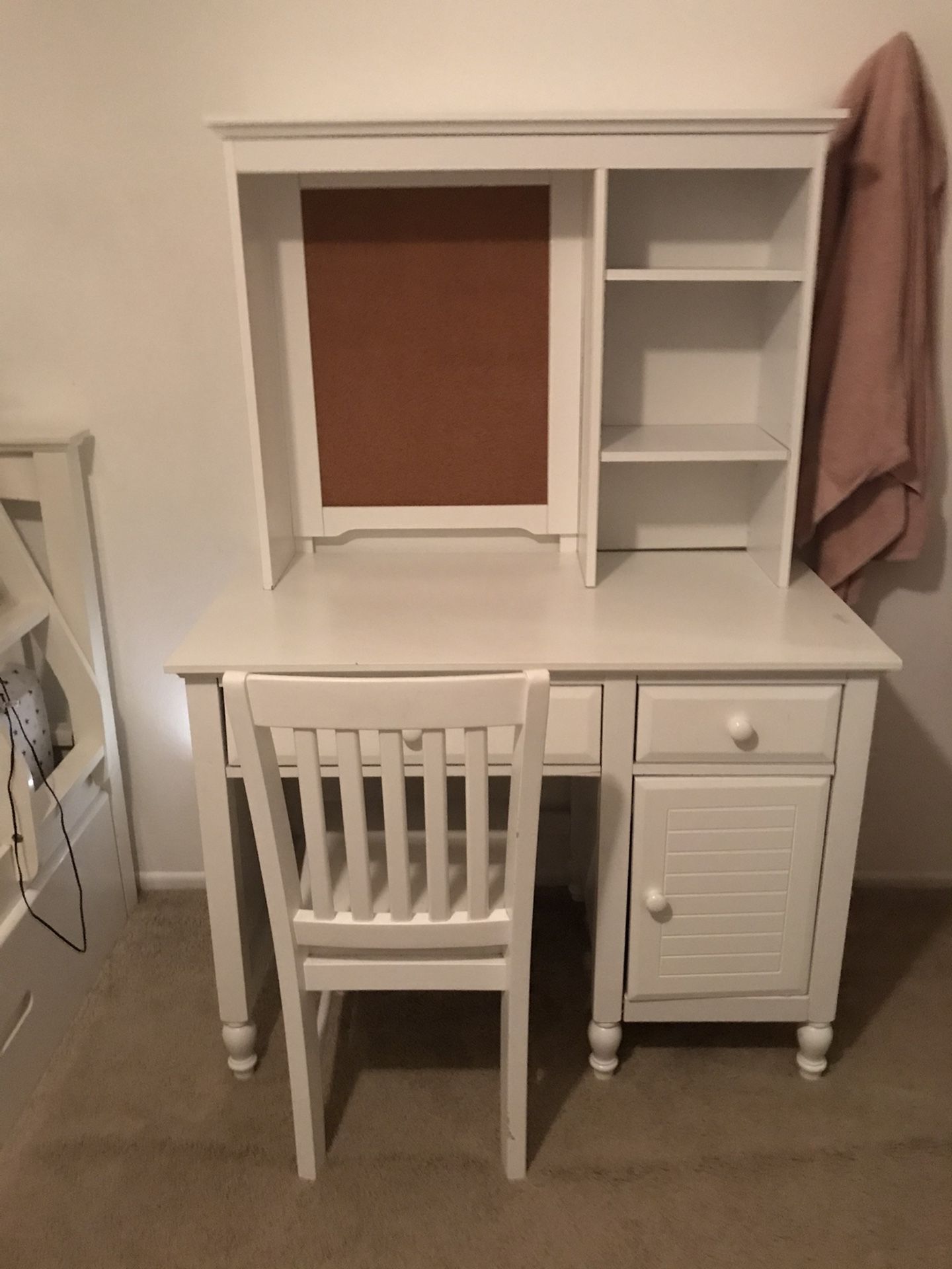 White desk with cork board hutch and chair