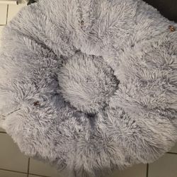 plush grey donut-style calming pet bed.