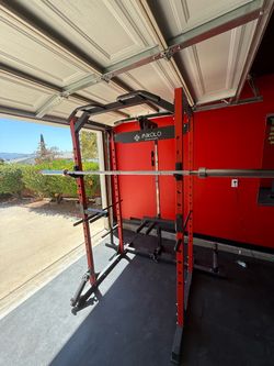 Mikolo multi-function power rack / squat rack with cable pulley system and Olympic barbell included.