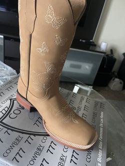 Stylish cowboy boots with intricate embroidery. Perfect woman’s