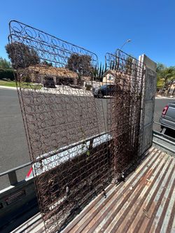 Three Rusty bedsprings for outdoor decor.