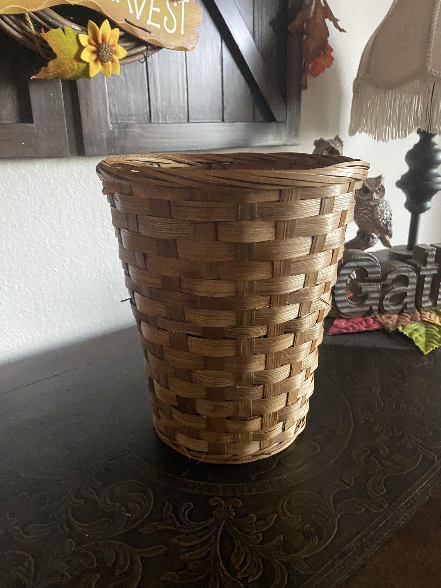 round, hand-woven rattan or wicker wastebasket or pot