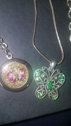 4 Necklaces 2 with Butterfly Pendants. One is a locket . 2 more silver toned chains. Costume jewelry. Vintage