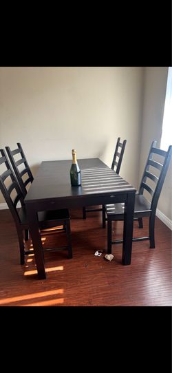 Nice black dining table with four chairs and extension