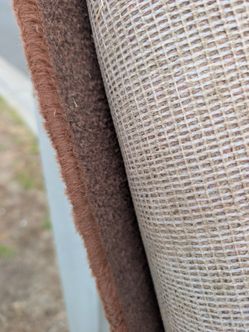 Large roll of brown carpet, suitable for home use.