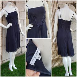 Blue Carolina Herrera sleeveless silk midi dress featuring pleated accents at front,