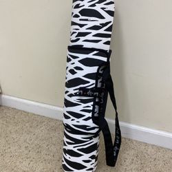 Black and white patterned red reversible yoga mat with strap