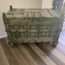 Vintage green storage cabinet on wheels