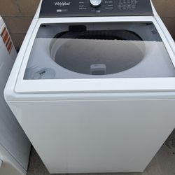 Top-load Whirlpool washing machine in good condition.