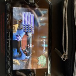 PSP With Charger, Case, 10 Games and 16 Movies. 
