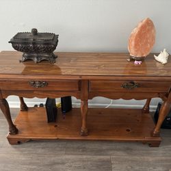 vintage-style wooden console table with a polished cherry stain finish