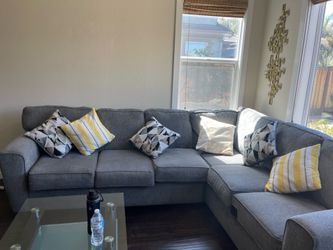 Grey soft couch with pillows
