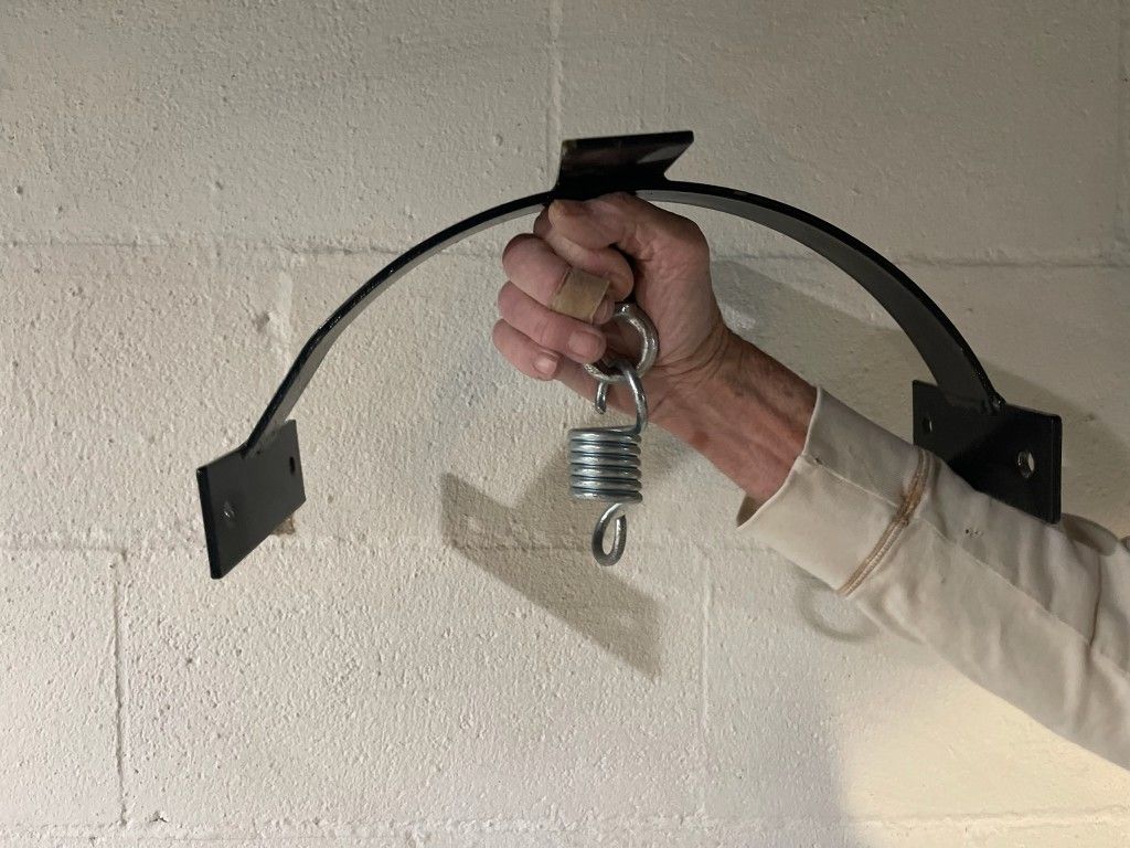 Punching bag holder for between rafters