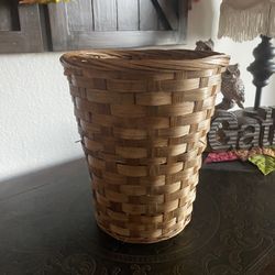 round, hand-woven rattan or wicker wastebasket or pot