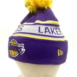 New Era Los Angeles Lakers cuffed knit hat with a pom. The purple, yellow, and white beanie features the Lakers team logo embroidered on the cuff and 