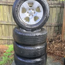 18” Dodge Rims. ( Tires hold Air. Fair Condition). 275 65 18.