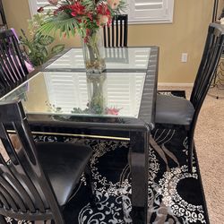 Glass table with 4 chairs.