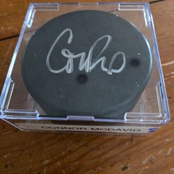 Autographed hockey puck of Connor McDavid with certification