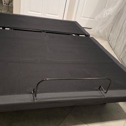 This is a modern queen-sized electric adjustable bed base with a dark grey finish. It has a split design that facilitates easy movement and individual