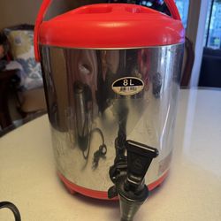 Stainless steel 8L beverage dispenser with red lid and handle.