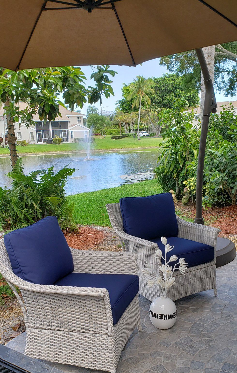 Two brand new large wicker patio club chairs with plush navy cushions
