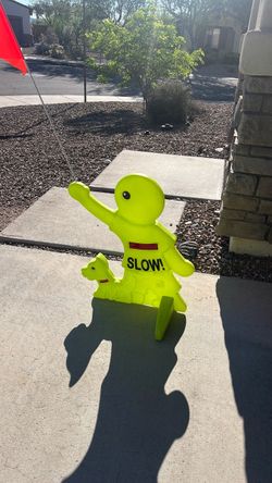 Neon Yellow SLOW Sign Child Figure with Flag