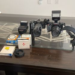 Two Minolta Cameras And Lenses