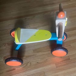 Wooden toddler ride-on toy with 4 wheels