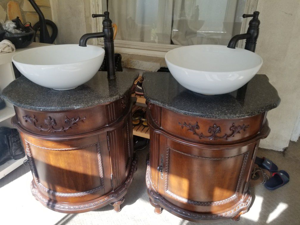 Round vanity cabinets with attached granite tops and vessel sinks