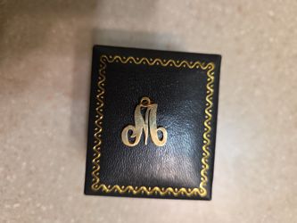 14 k gold letter M pendant.  Weight is 1.8 grams