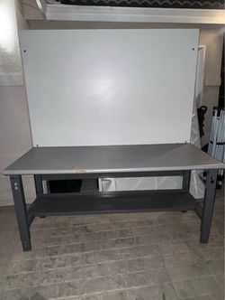 Workbench with back riser panel and a lower storage shelf