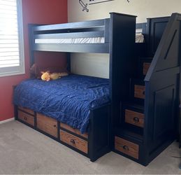 Bunk  bed and desk with dresser drawers.