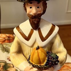 Pilgrim Statue With Corn Legs and Hat Holding aPumpkin 
