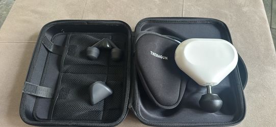 Mini Theragun with accessories and case