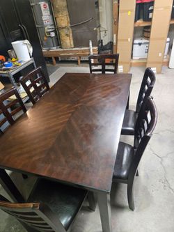 Dark brown dining table with 6 chairs