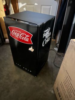 Small fridge with freezer and bottle opener attached