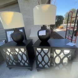 Two black mirrored nightstands with matching lamps
