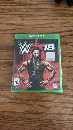 Two xbox controllers and two WWE video games