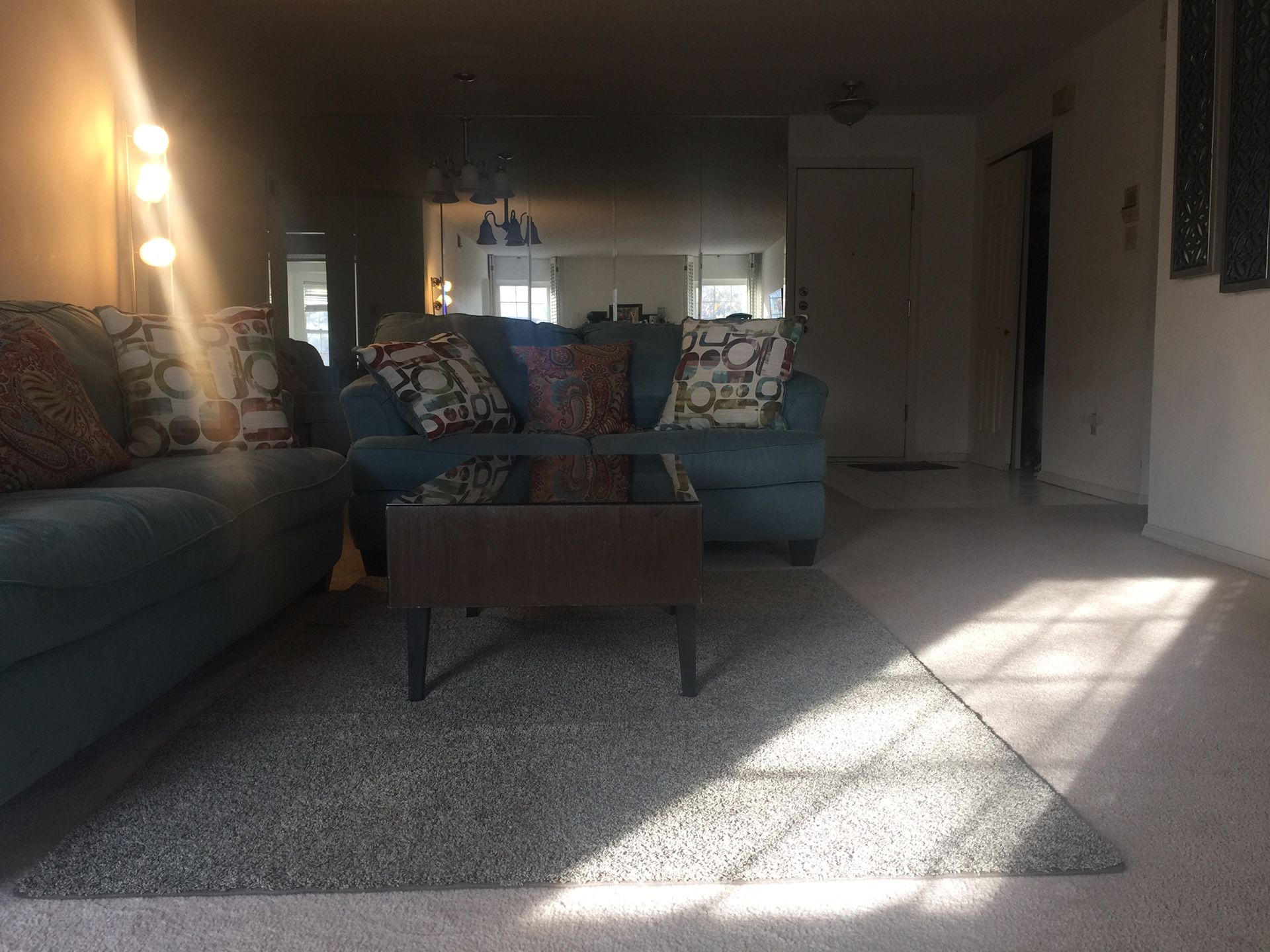 Two sofa, a coffee table, and blue rug.
