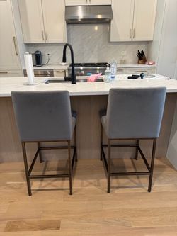 2 grey counter stools