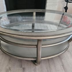 Coralayne round coffee table with a silver metallic finish and beveled glass inlays.